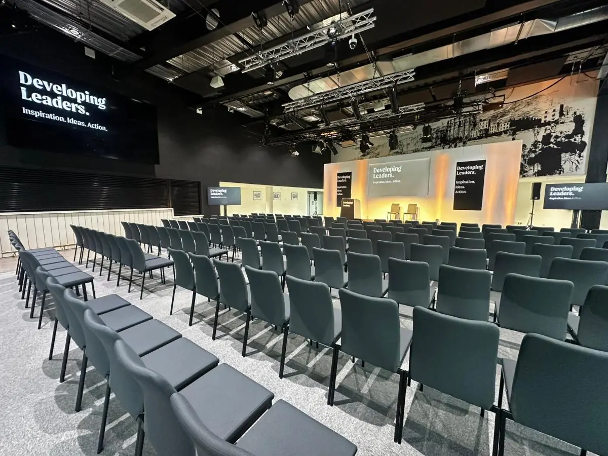 A conference room laid out theatre-style with a presentation stage