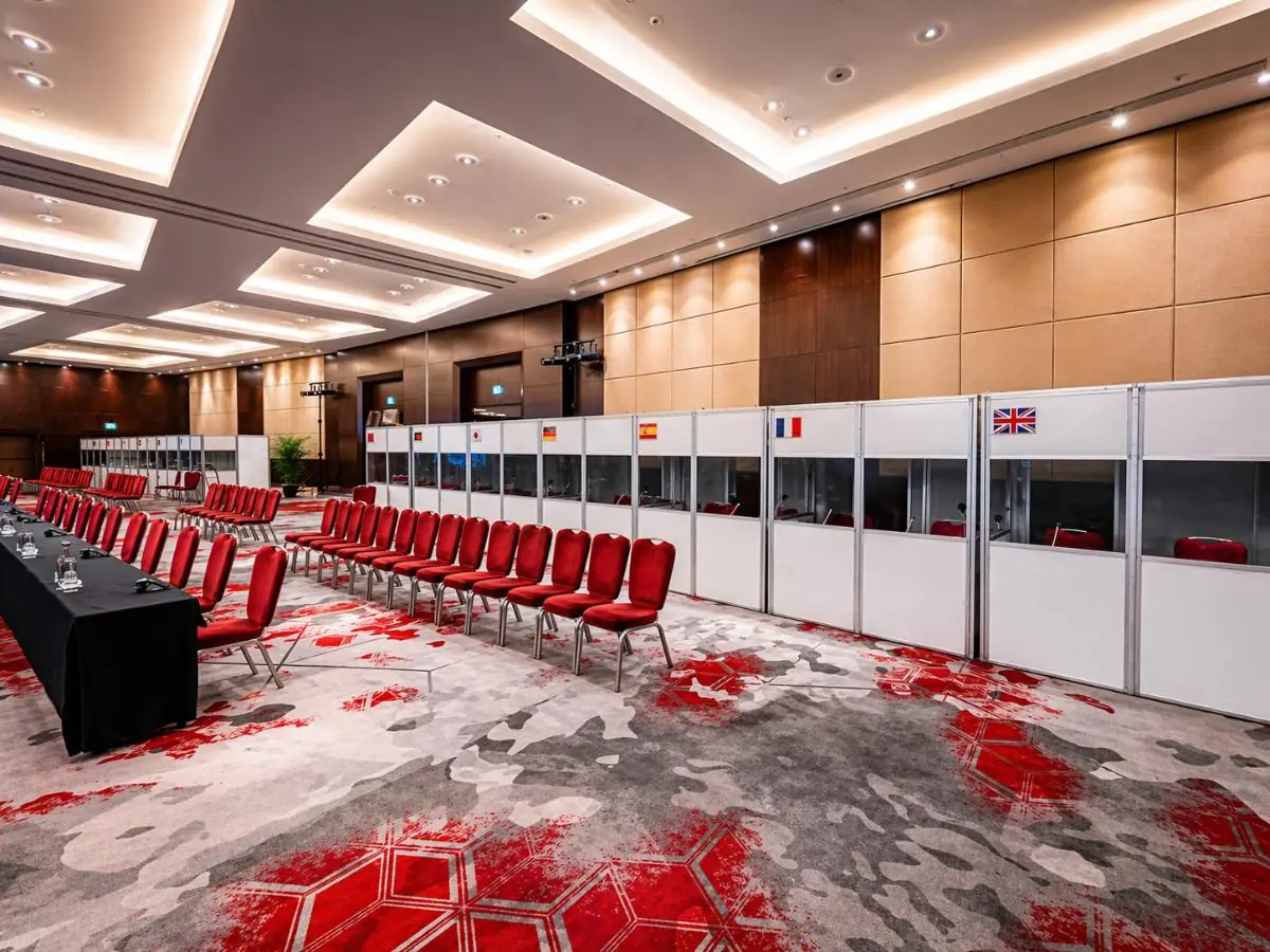 A conference suite laid out with interpretation booths and national flags